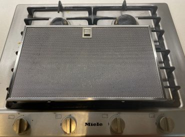 Rangehood Filter Metallic range hood filter on stove